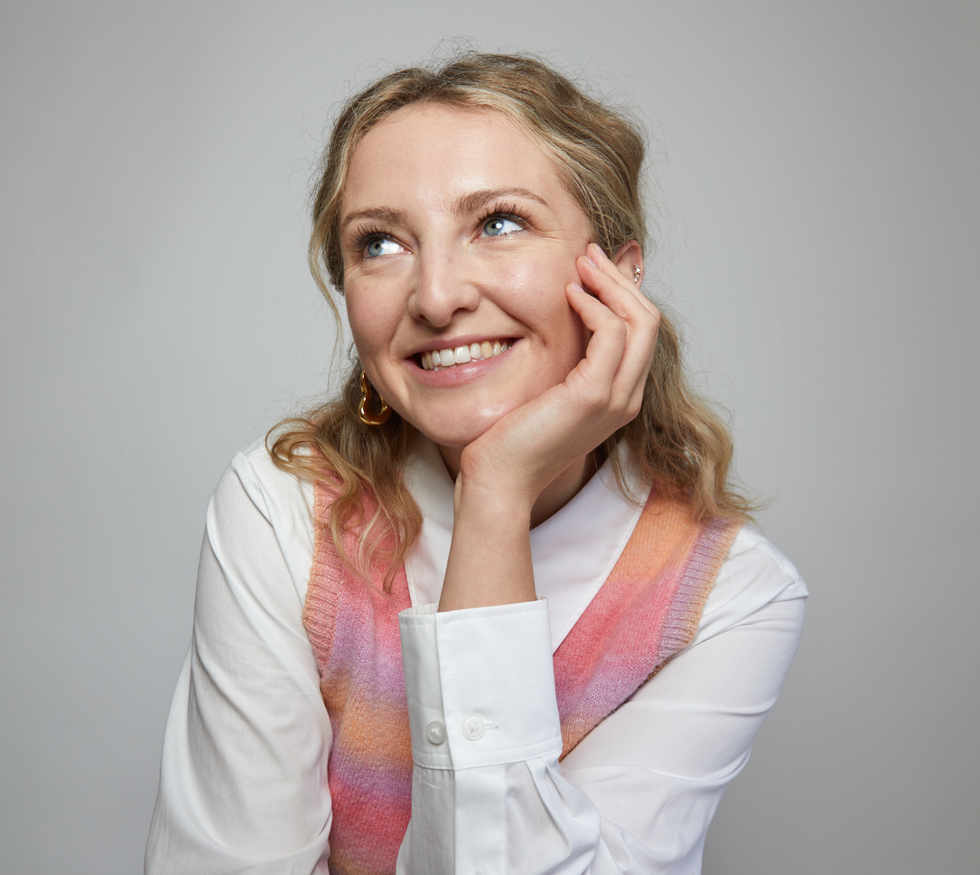 a woman with her hand on her face